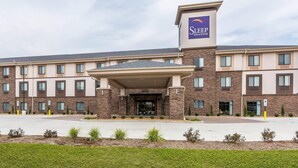 A Sleep Inn & Suites hotel with a modern brick facade, a covered entrance, and a parking lot. - Sleep Inn & Suites O'Fallon MO - Technology Drive (O'Fallon)