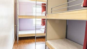 A bunk bed room with a window and curtains.