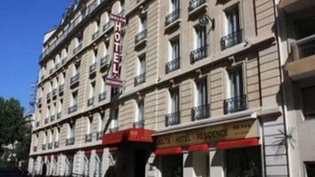 A multi-story hotel with a prominent sign indicating 'HOTEL' and 'RESIDENCE.' - Belta Hotel Residence (PARIS)