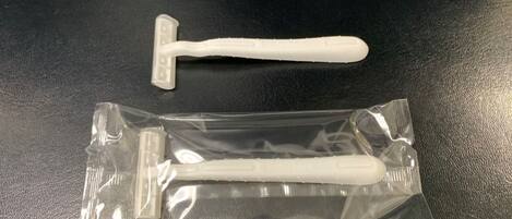 Eine Plastiktüte mit einem weißen Gegenstand mit Henkel und einem kleineren weißen Gegenstand mit flacher Kante.