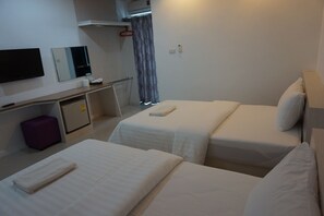 A hotel room with two beds, a desk, a television, and a mirror. - NN Place (Udon Thani)