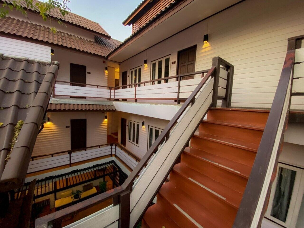 A multi-story building with a wooden staircase and a balcony.