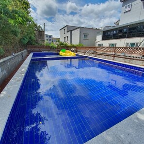 Outdoor pool, open 9:00 AM to 7:00 PM, pool umbrellas, pool loungers