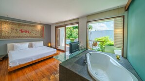 A modern bedroom with a bed, a bathtub, and a balcony with a view of greenery. - Villa Rio (Seminyak)