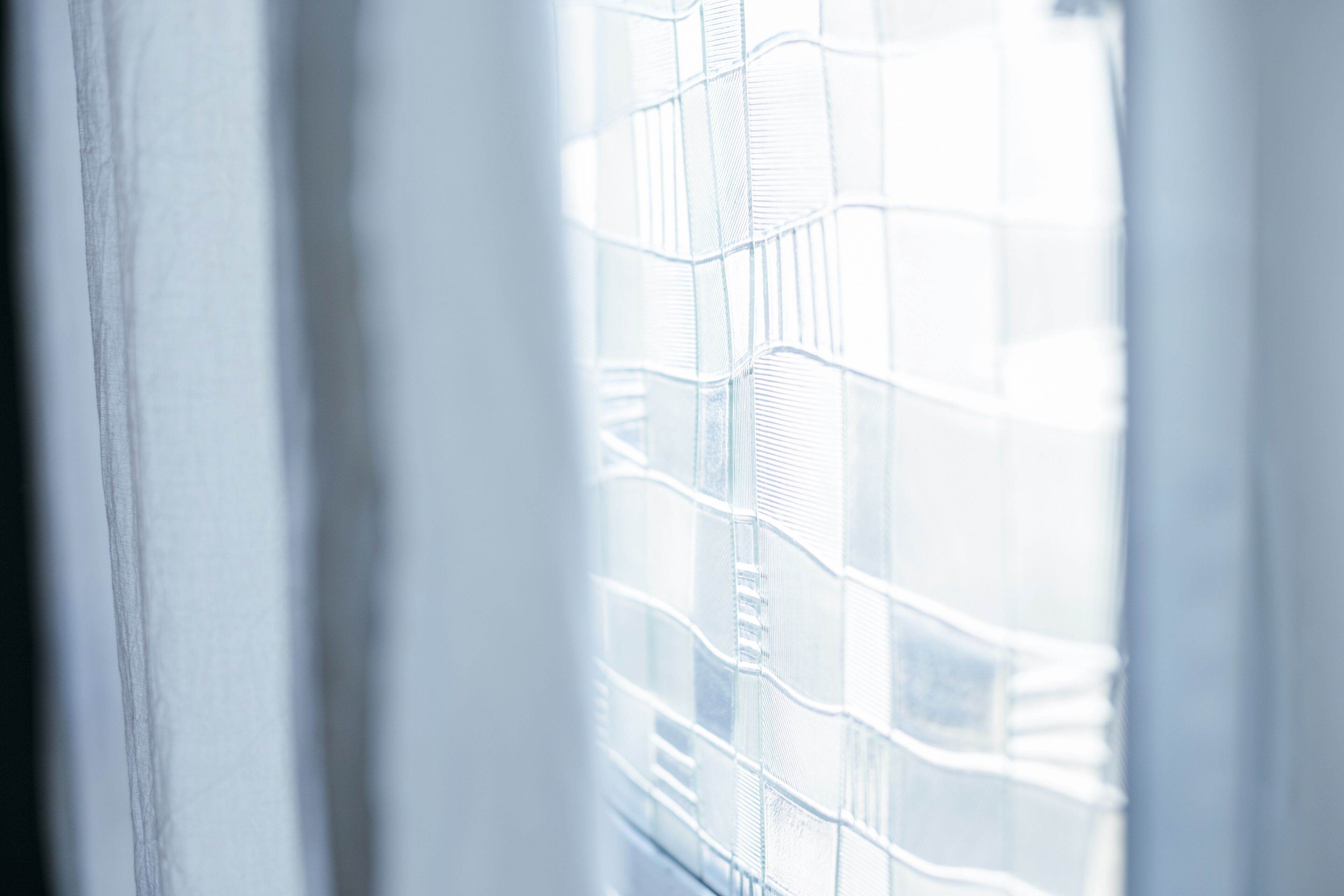 A view through a window with a metal grid pattern.