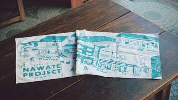 A brochure titled 'Nawate Project' on a wooden table.