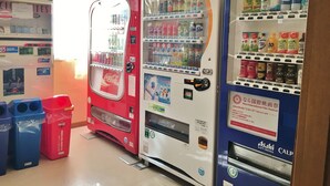 A vending machine area with various drink options, including Coca-Cola and Asahi soft drinks. - Hounkan (Yoshino)