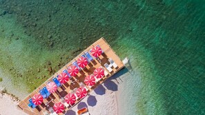 On the beach, sun-loungers, beach umbrellas, snorkelling
