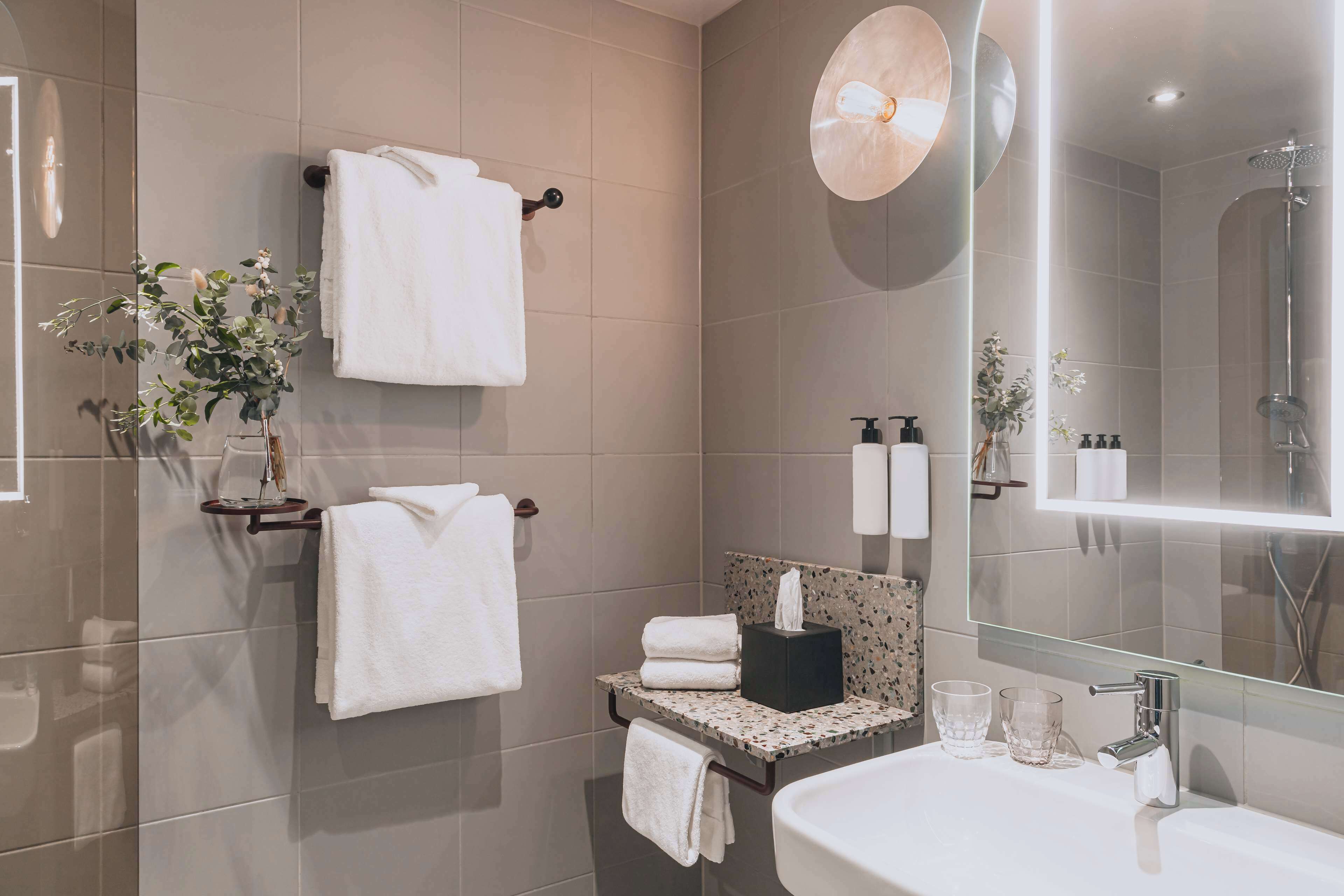 designer toiletries, hair dryer, towels