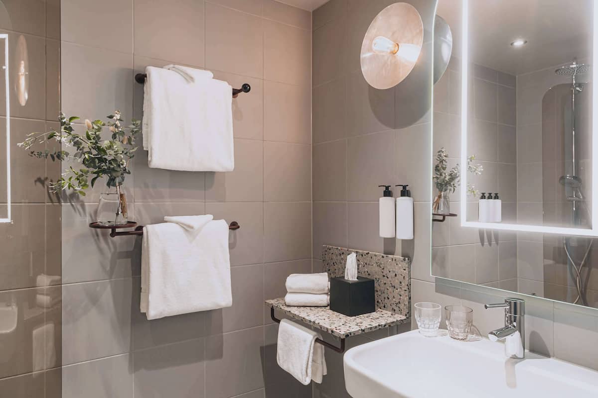 designer toiletries, hair dryer, towels