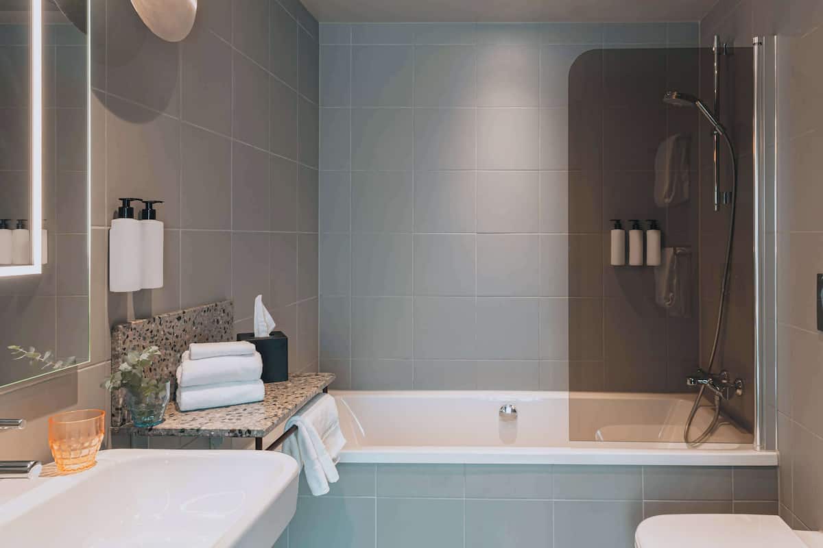 junior suite, 1 king bed, ocean view | bathroom | designer toiletries, hair dryer, towels