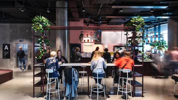 A modern indoor space with a bar area, seating, and a counter.