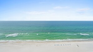 A beach with a clear sky and calm sea.