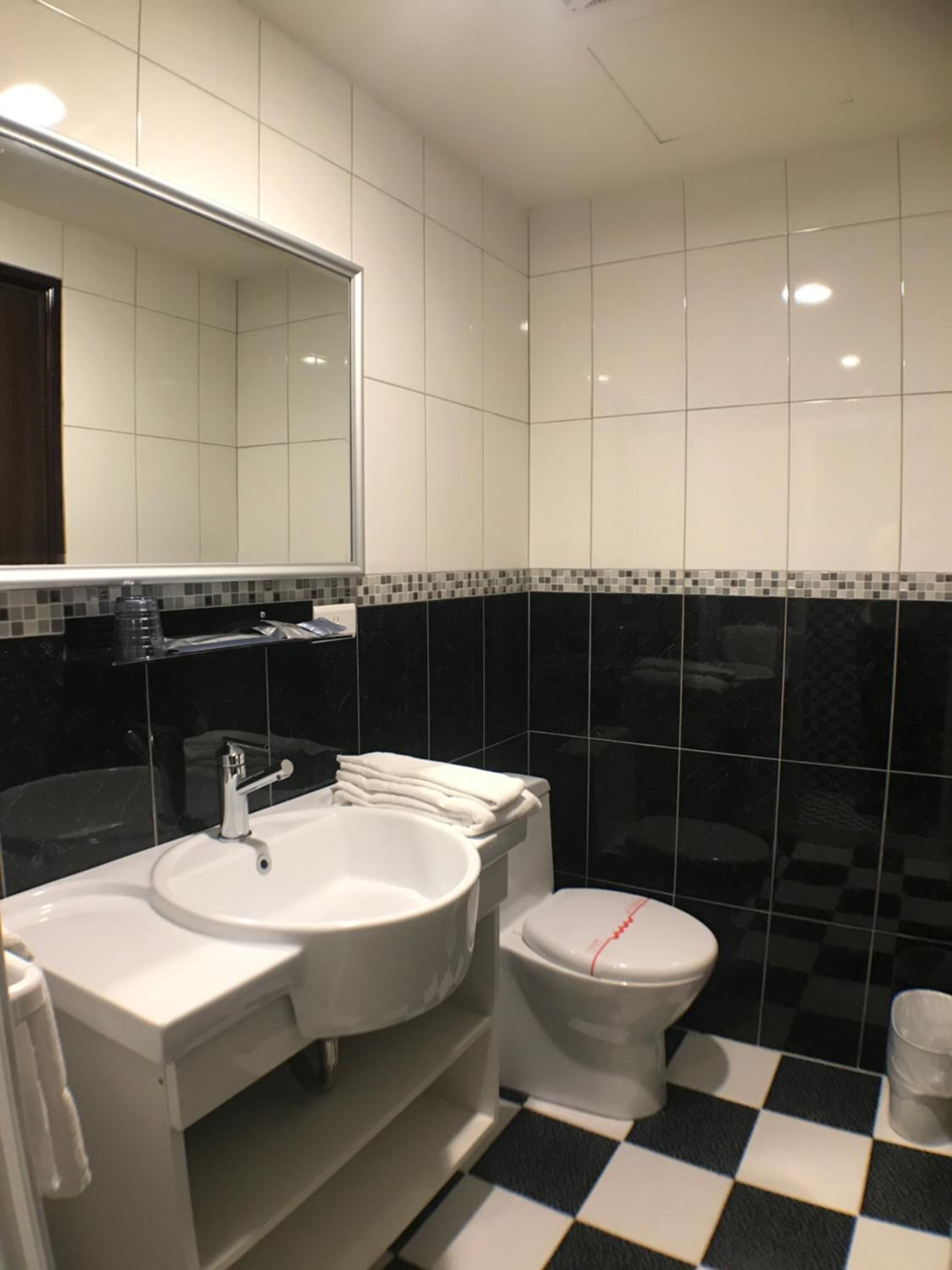 shower, hair dryer, slippers, towels