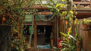 A rustic entrance with a rope archway, wooden door, and lush greenery. - Grajagan Surf Resort (Paranaguá)