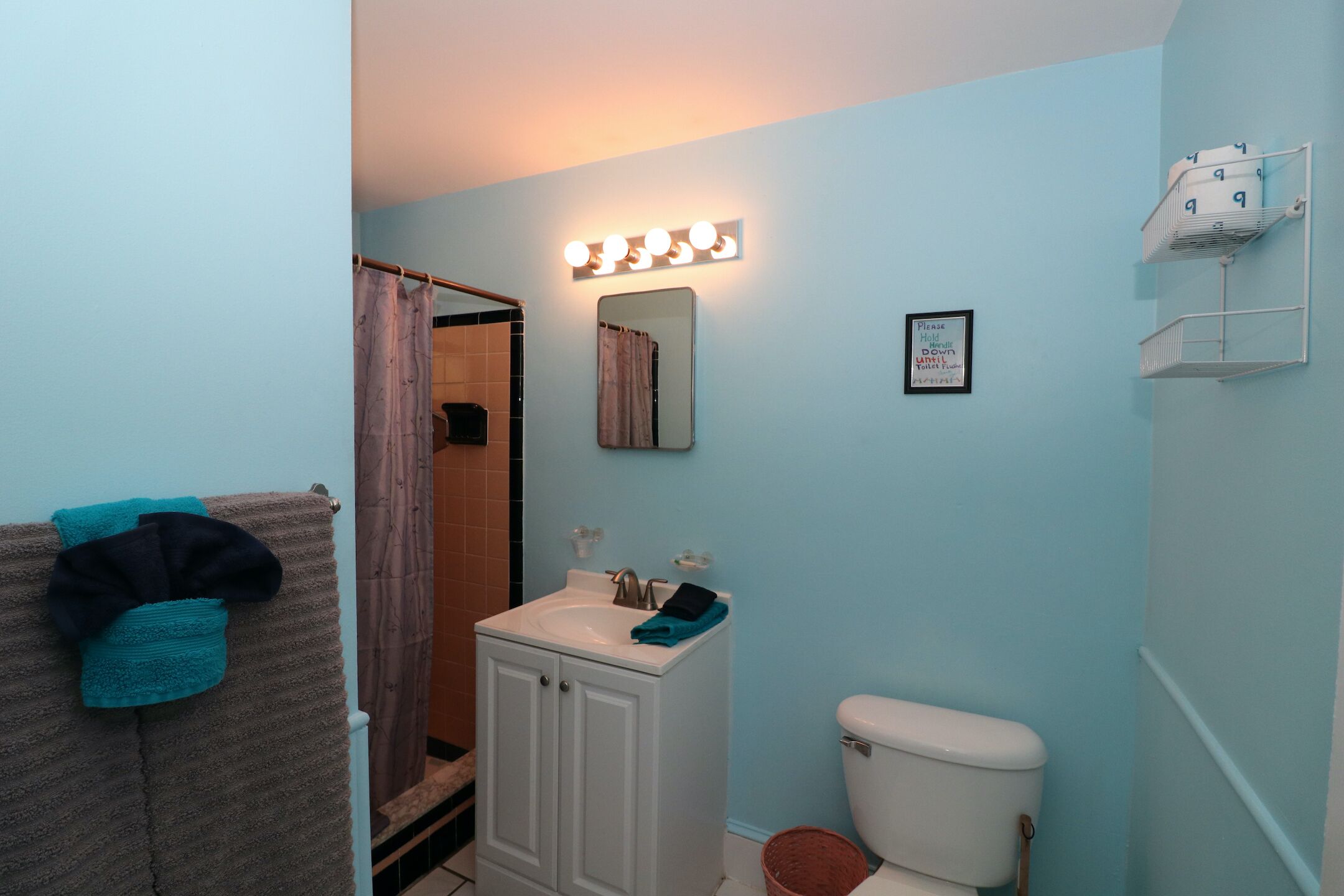 A bathroom with a sink, mirror, and vanity cabinet.