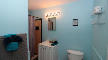 A bathroom with a sink, mirror, and vanity cabinet.