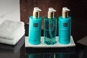 Três frascos de produtos Ritual of Karma sobre um tabuleiro branco.