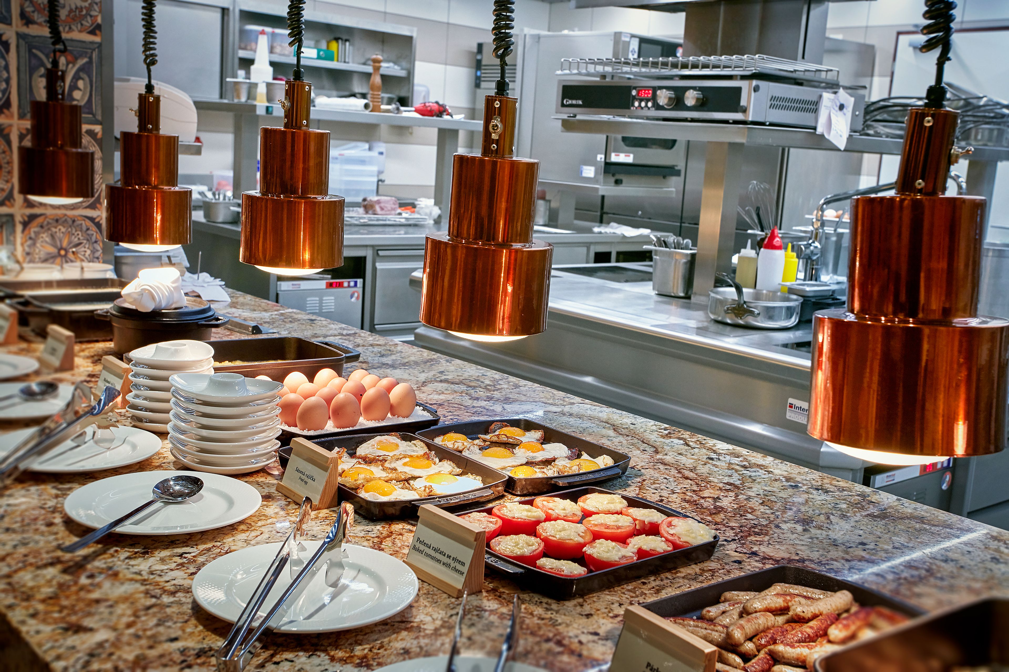 A buffet setup with various food items and utensils.