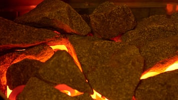 A close-up of glowing coals in a fireplace.