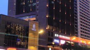 A modern hotel with a prominent vertical design, illuminated windows, and a visible 'Hampton' sign. - Hampton by Hilton Guangzhou Zhujiang New Town (Guangzhou)
