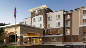 A hotel with a stone facade, multiple floors, and a central entrance with a canopy. - Homewood Suites by Hilton Augusta (Augusta)