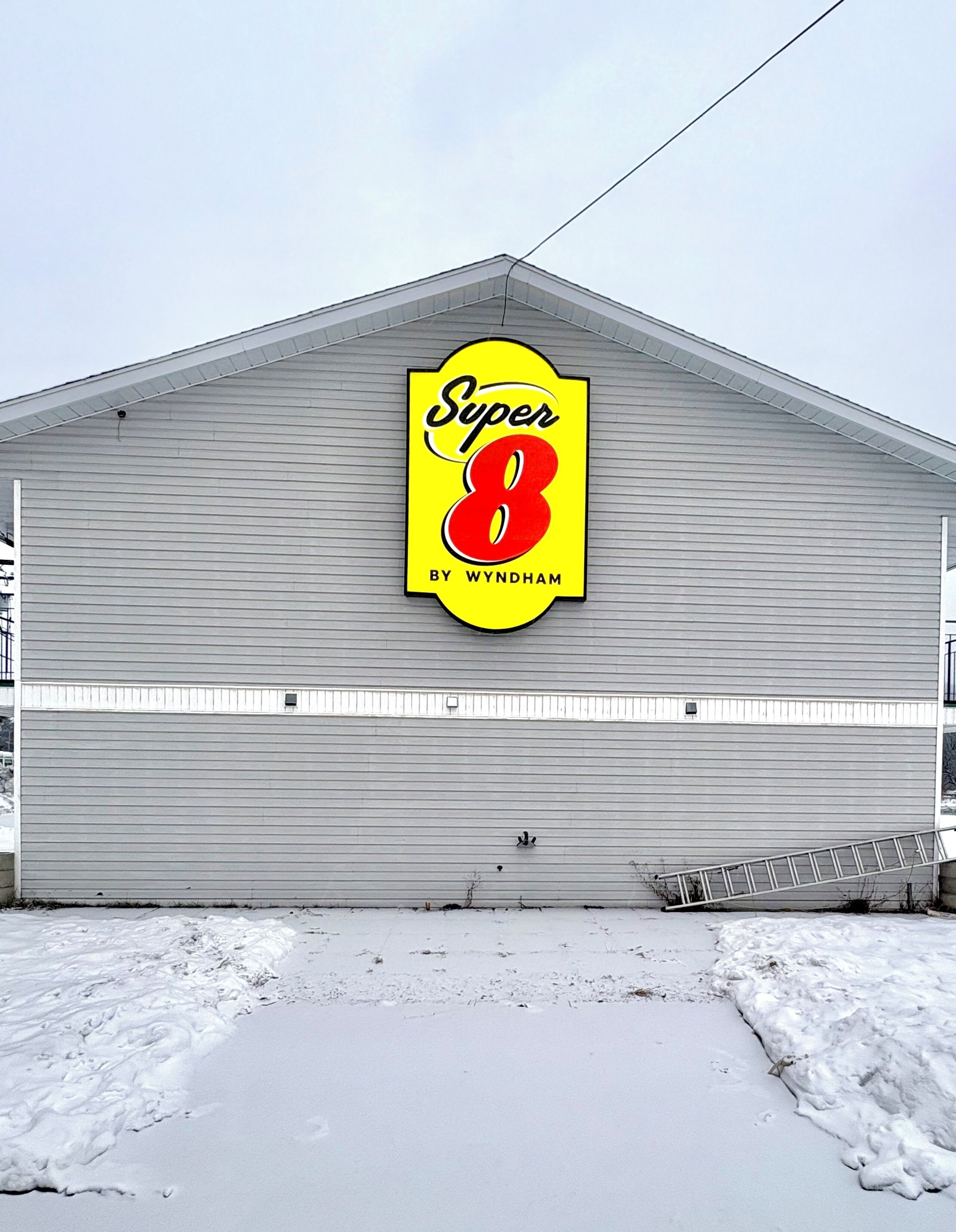 A building with a large sign reading 'Super 8 by Wyndham' on its side.