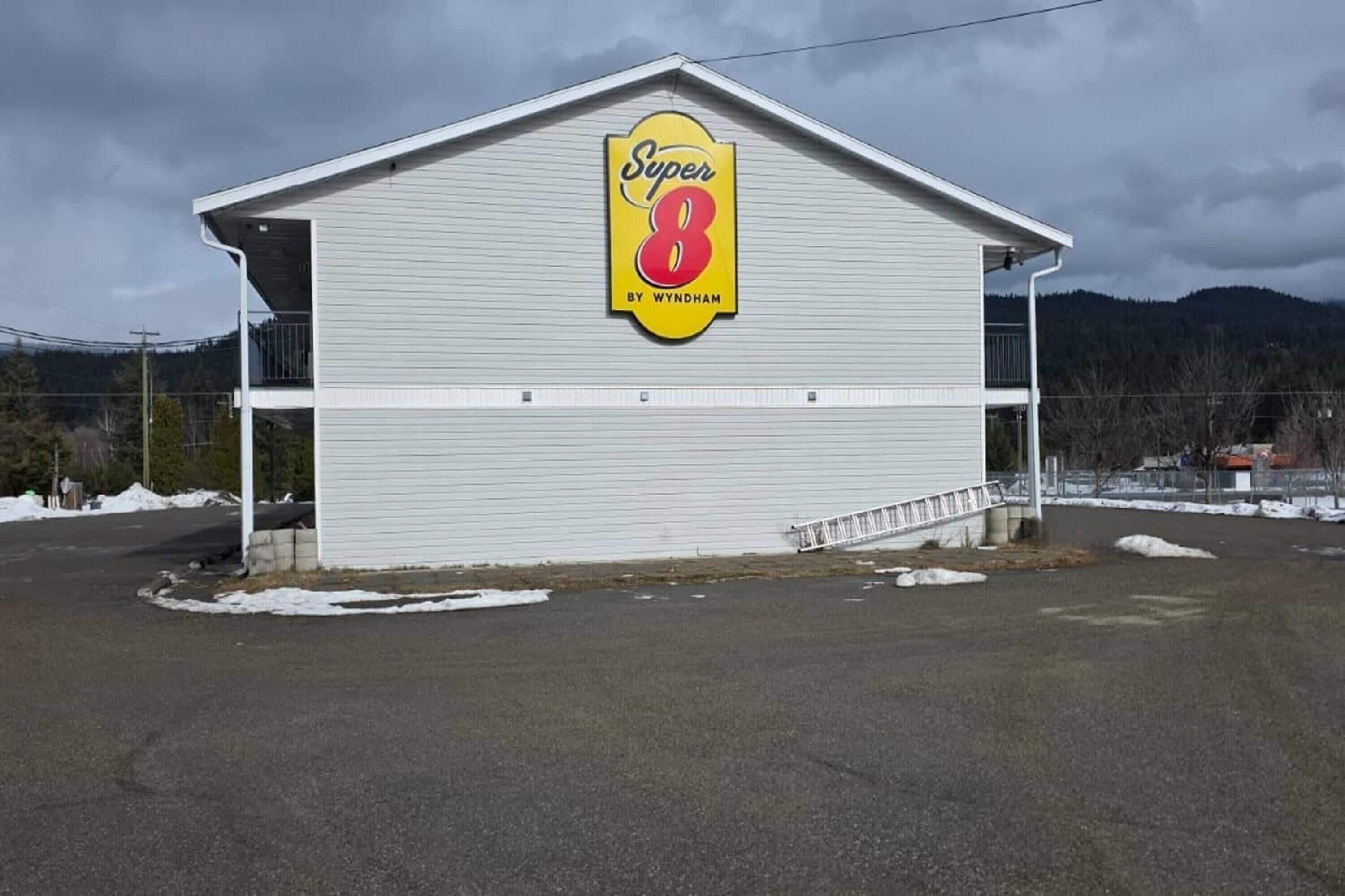 A large, single-story building with a prominent sign reading 'Super 8 by Wyndham.'