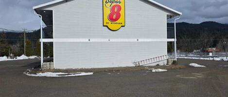 A large, single-story building with a prominent sign reading 'Super 8 by Wyndham.'