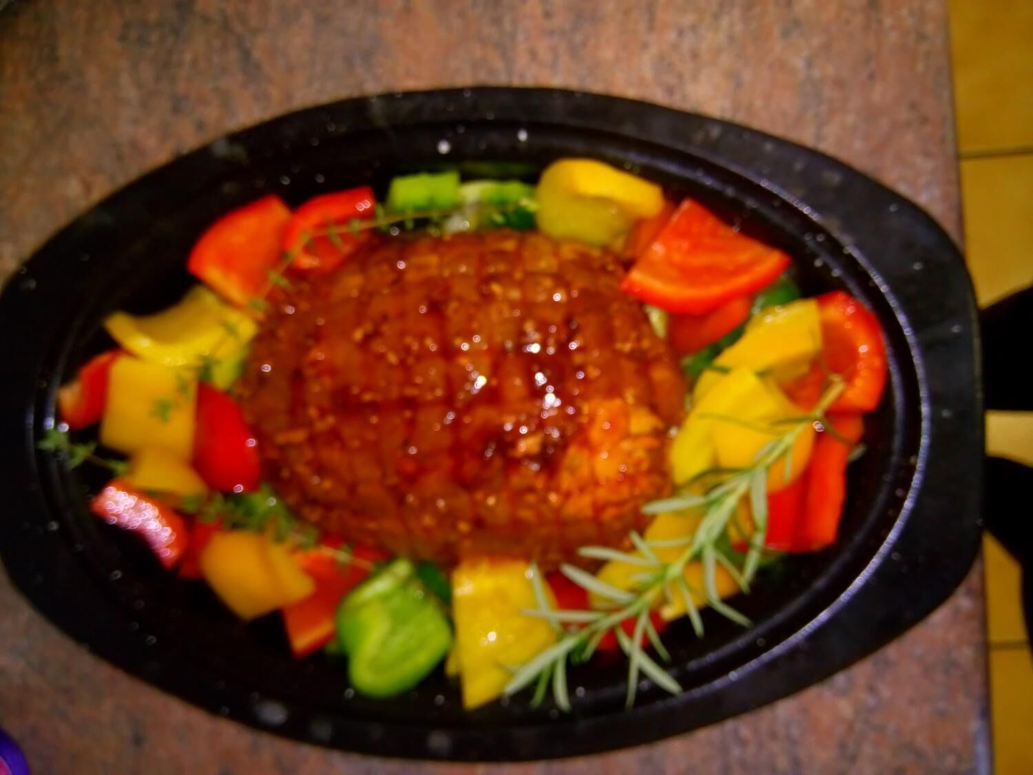 A dish with a central sauce surrounded by various vegetables.
