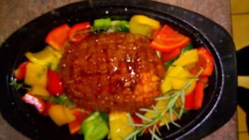 A dish with a central sauce surrounded by various vegetables.