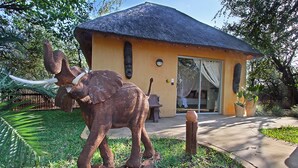 Un edificio con techo de paja y una estatua de un elefante en su fachada.