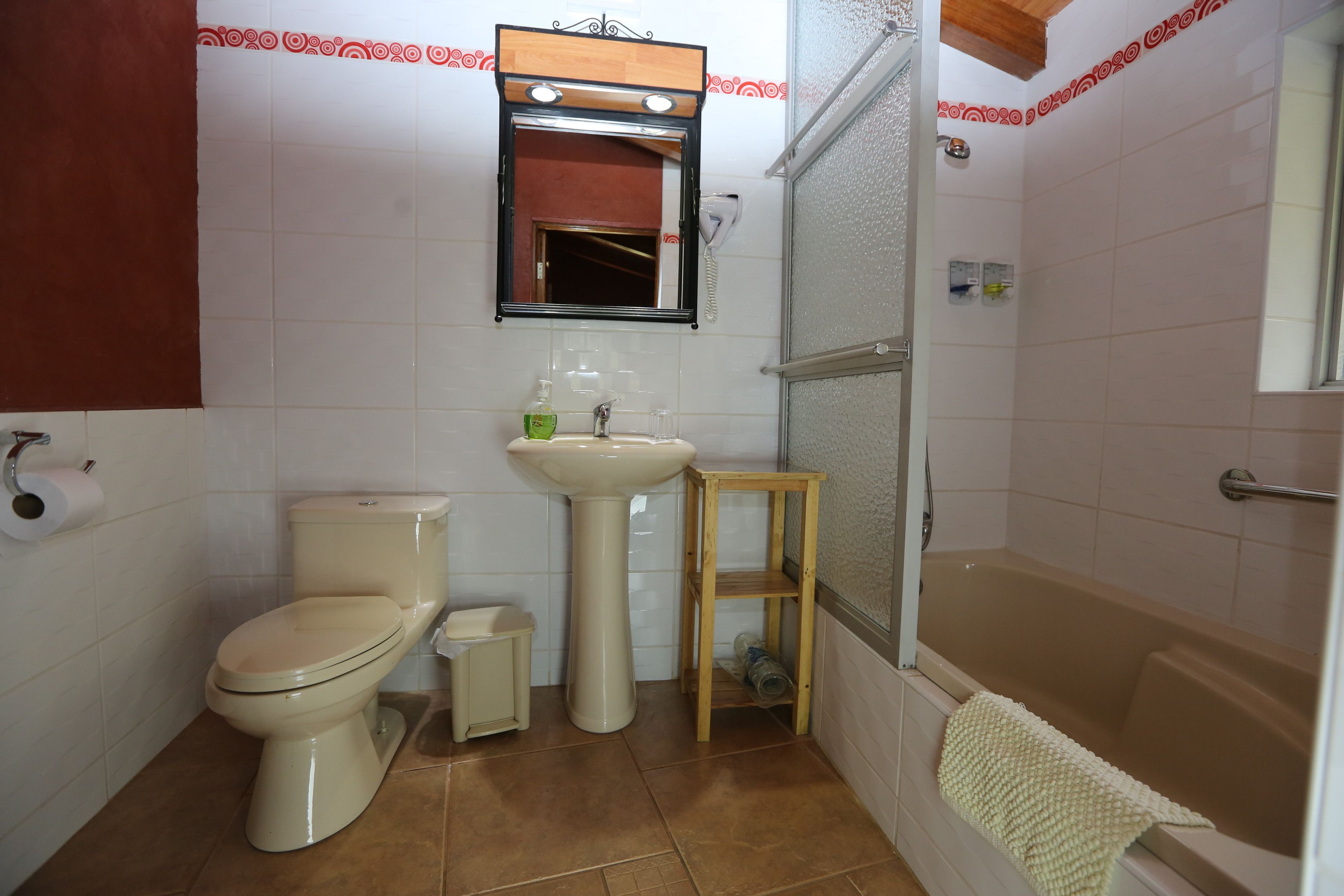 Casa de banho com sanita, lavatório e banheira.