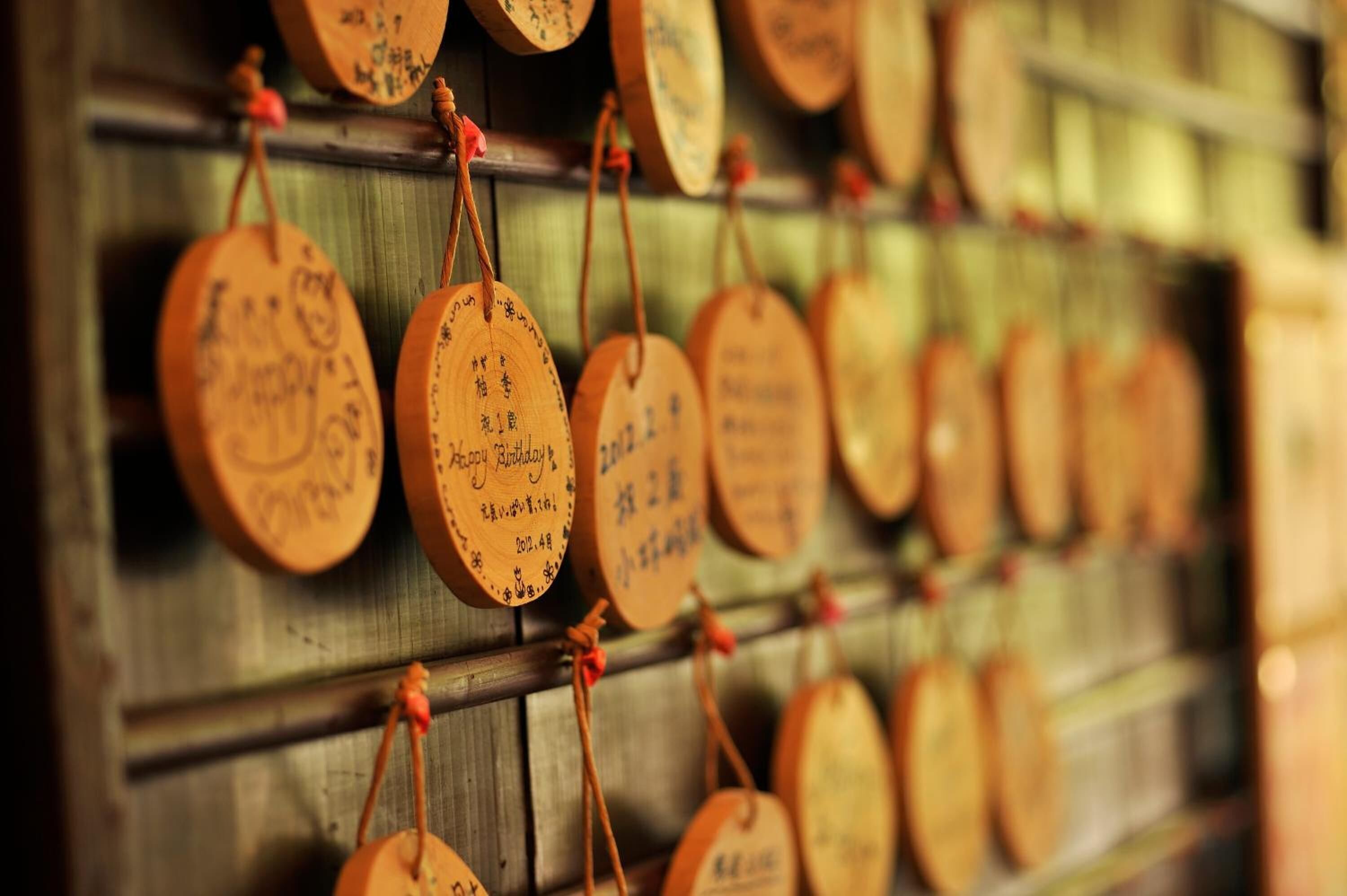 Wooden plaques with text on a wall.