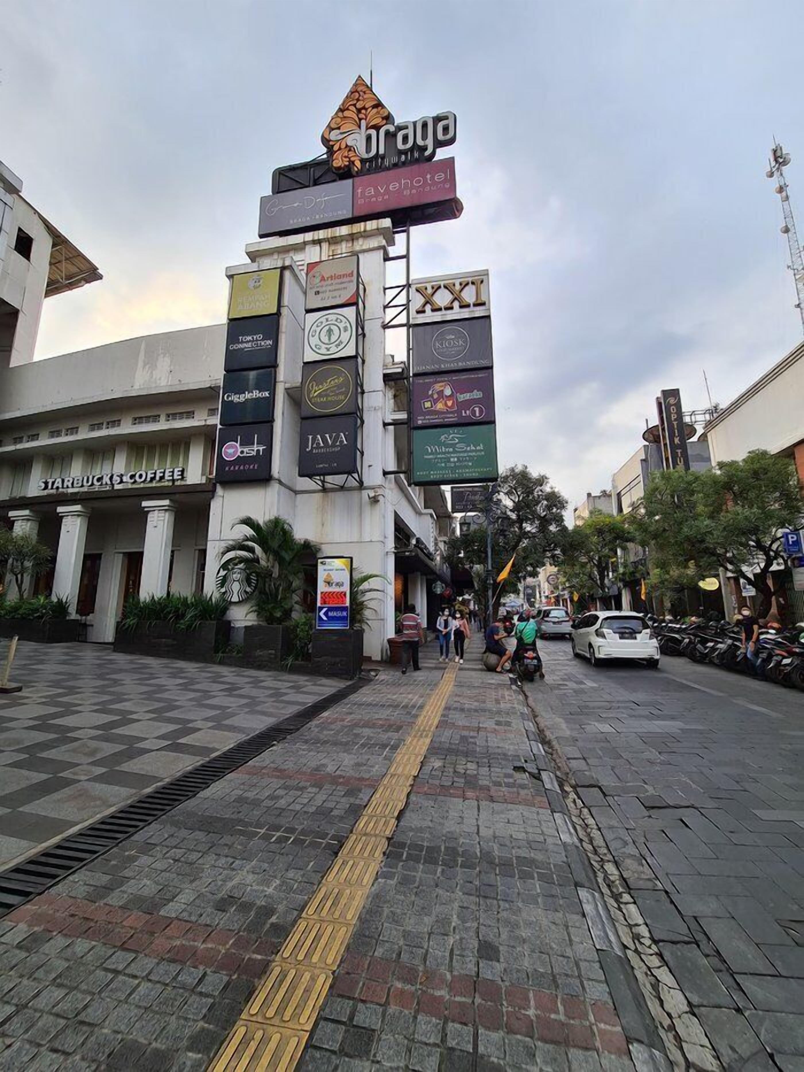 A street with a variety of commercial signs, including a cafe and a hotel.