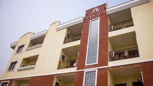 A multi-story hotel with a prominent sign reading "Sun Heaven Hotel". - Sun Heaven Hotel & Resort Lekki (Lekki)