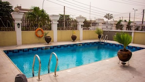 A rectangular swimming pool with a tiled edge, surrounded by a tiled deck. - Sun Heaven Hotel & Resort Lekki (Lekki)