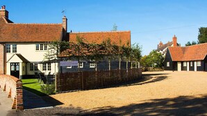 A traditional brick building with a gravel driveway and a fenced area. - The Harvard Inn (Ingatestone)