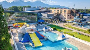 A resort with a large pool, water slides, and a glass building. - Apartments Ceresnovy Sad (Mengusovce)
