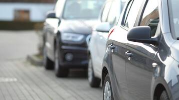 A row of parked cars on a paved surface.