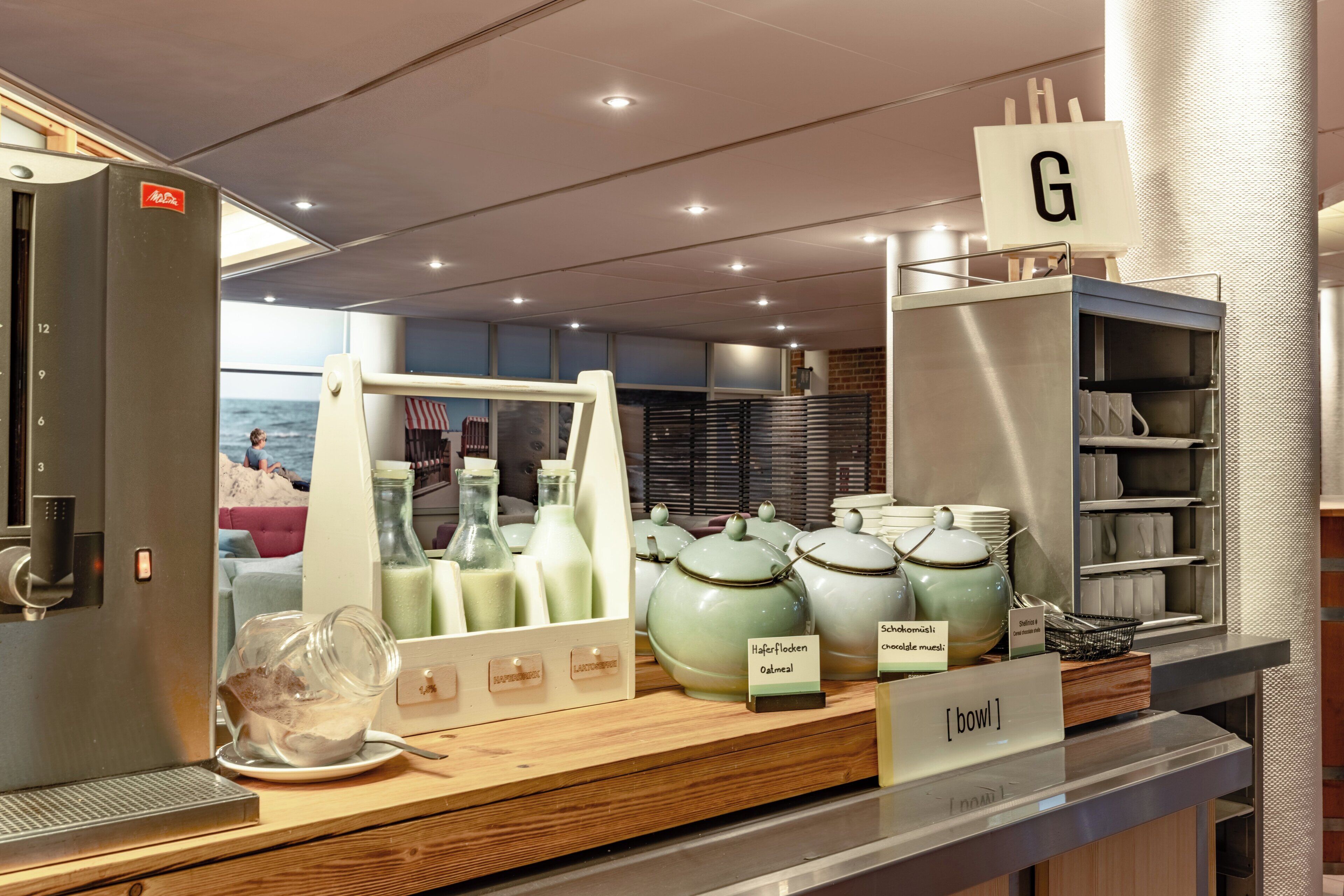 A breakfast buffet with various food items and a coffee machine.
