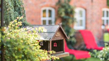 Experience the charm of a traditional German-style hotel, nestled among lush greenery and historic architecture.