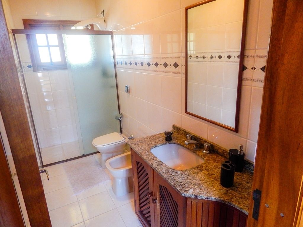 A bathroom with a toilet, sink, and shower.