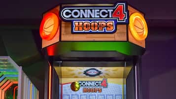 A Connect 4 Hoops arcade machine with a basketball hoop, a scoreboard, and a "Red" and "Yellow" team section.