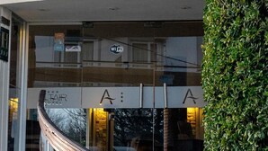 The exterior of the Altair Hotel with a visible staircase leading to the entrance, a balcony with a railing, and a well-maintained hedge to the right. - Hotel Altair (San Clemente)