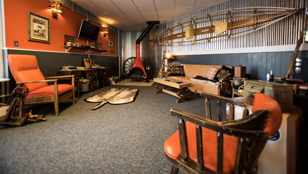 A cozy living room with a fireplace, a television, and a variety of seating options including a sofa and chairs.