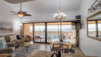 Pool-Side Condo | Living area | Flat-screen TV, DVD player