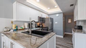 Courtyard Condo | Private kitchen | Full-size fridge, microwave, oven, stovetop