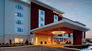 A modern hotel with a prominent entrance, large windows, and a well-lit facade.