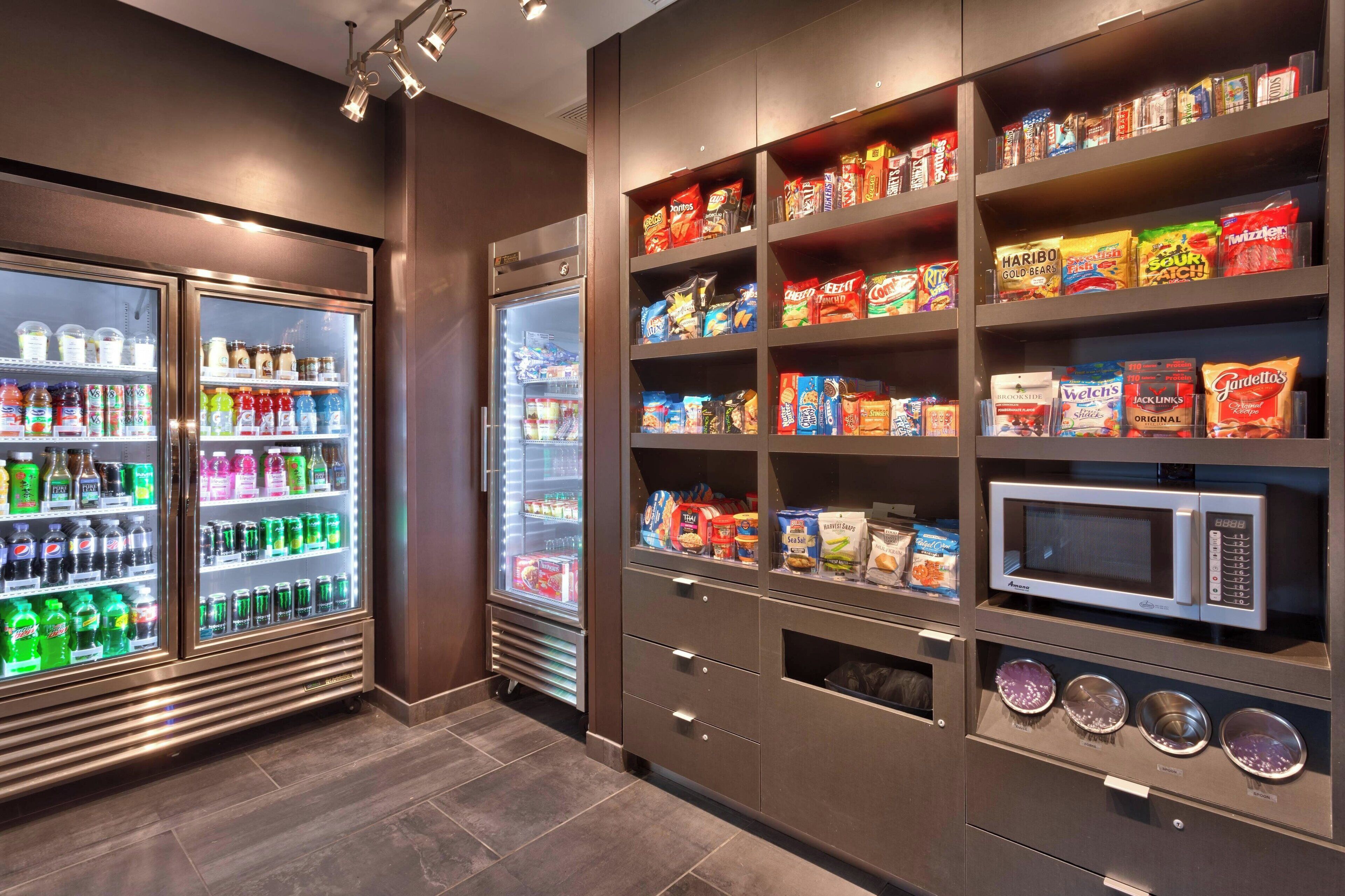 A vending area with various snack and drink options, including microwaves and beverage dispensers.